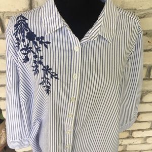 Women within blue stripped blouse with flower shoulder